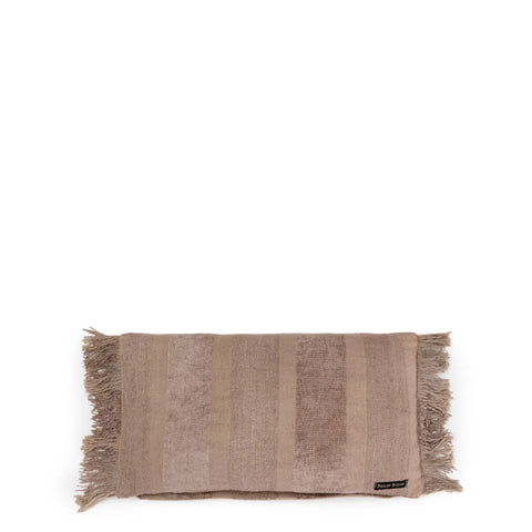 A folded light brown towel with fringed edges, exuding a boho vibe, is placed against a white background. The towel has a tag in the corner.