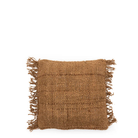 A square burlap pillow with fringe on all sides is displayed on a plain white background. Featuring a textured, rustic appearance and a natural brown color, this piece effortlessly exudes a boho vibe.