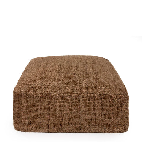 A large, square, brown textured cotton pouffe against a white background. This charming home accessory features hand-dyed woven fabric with a slightly rough appearance, offering a minimalist and rustic look.