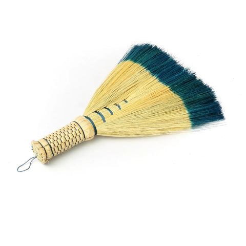 This Indonesian hand sweeper is a boho must-have, featuring natural straw bristles and a woven handle. Dark green bristles add flair, while a looped string offers easy hanging.