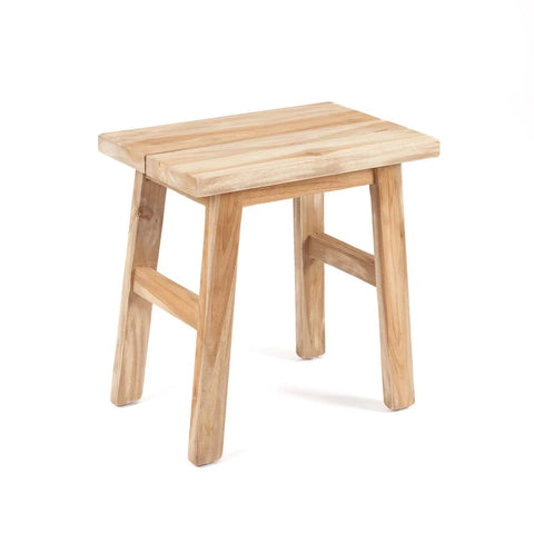 The Makara stool features a rectangular seat and four legs made from reclaimed teak wood, giving it an eco-friendly appeal. Its light-colored finish and simple, rustic design make it a charming addition to any space.