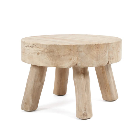 A rustic, round wooden stool made from reclaimed teak wood, featuring a smooth top and three thick, natural wood legs. The light finish highlights the visible grain and texture, making it a perfect piece of sustainable furniture.