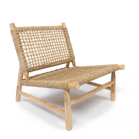 A rustic wooden chair with a woven rattan seat and backrest exudes a tropical vibe. The design is simple and minimalist, highlighting natural fibers. With a slightly reclined position, the Island Sisal One Seater ensures a casual and comfortable look.