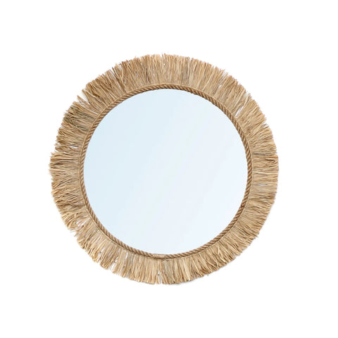 A round mirror with a frame made of Indonesian raffia, creating a fringed, textured border. This boho touch is beautifully centered against a plain white background.