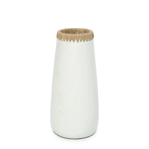 A white, tapered ceramic vase with a smooth, glossy finish features a beige raffia detail resembling straw at the top, adding a rustic touch to the modern design. Perfect for showcasing dried flowers around your home.