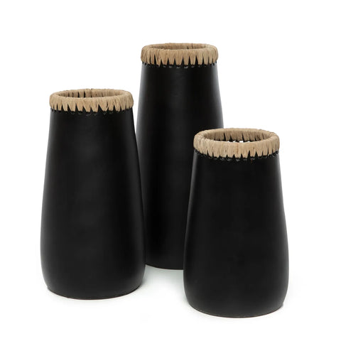 Three black ceramic vases with tan woven tops and raffia detail are arranged together. The vases vary in height, offering a simple yet elegant design against a plain white background, perfect for showcasing dried flowers.