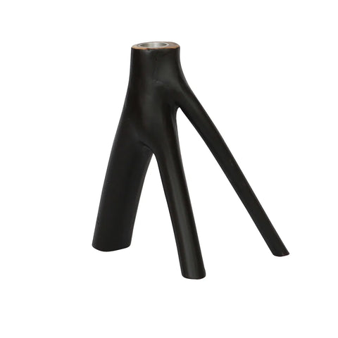 A black, three-legged tripod-like object crafted from sleek, curved material features a unique organic design. The top part has a small, round opening perfect for cozy candlelight. Its legs angle outward to form a stable base, making it an ideal decorative interior piece.