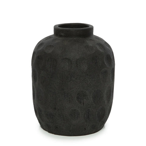 A textured, dark gray ceramic vase with a rounded body and short neck boasts a subtle ribbed texture. The matte-finished vase, ideal for dried flowers, is set against a plain white background.