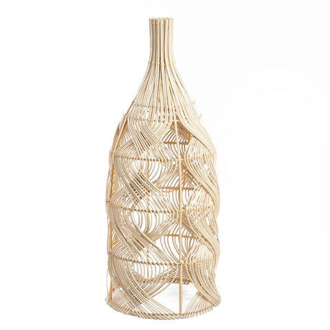 A tall, intricately woven rattan vase with a bottle-like shape doubles as a versatile lamp. The design features curved, interlacing patterns that create an elegant, airy appearance, effortlessly blending beauty and function.