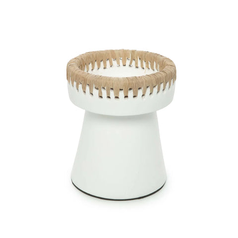 A white, cone-shaped stool with raffia woven around the top edge, creating a decorative rim. The stool has a wide base tapering towards the top, blending minimalist design with rustic elements.