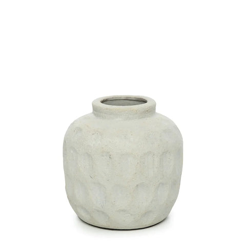 A textured, round, light gray vase with a short neck and small opening sits against a plain white background. The vase has a subtle, dimpled surface pattern reminiscent of ribbed textures, giving it a handcrafted appearance.