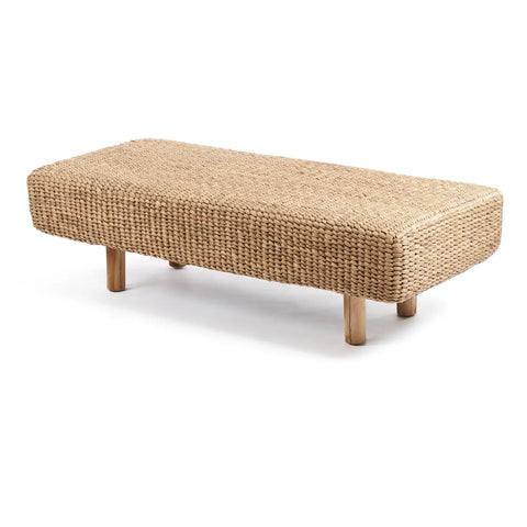 A rectangular Water Hyacinth Bench with wooden legs. The eco-friendly fibers add a rustic, bohemian vibe, perfect for indoor or outdoor use. This sustainable seating piece is set against a white background.