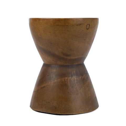 A bronze, hourglass-shaped stool or side table with a smooth, metallic finish complements organic furniture beautifully. Its simple, modern design is versatile, with a symmetrical structure and light-reflecting surface that highlights its polished texture.