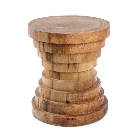 A round wooden table crafted from Indonesian suar wood, featuring a layered, column-like base. Its contemporary design highlights circular patterns in the wood grain, enhanced by a smooth, polished finish.