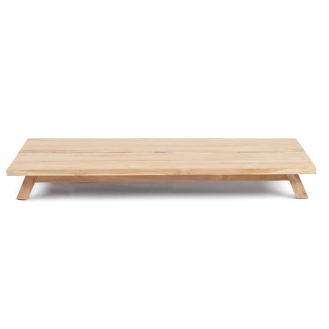 This minimalist wooden coffee table features a rectangular top and angled legs, crafted from recycled teak wood. Its design is simple and low to the ground, embodying an ecological aesthetic ideal for a modern living space.