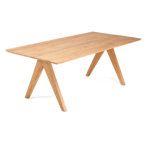 Wooden dining table with a rectangular top and angled trestle legs, crafted from reclaimed teak. Set against a plain white background, it features a smooth finish that highlights its natural grain. Ideal for modern or minimalist spaces, it's perfect for those embracing sustainable furniture choices.