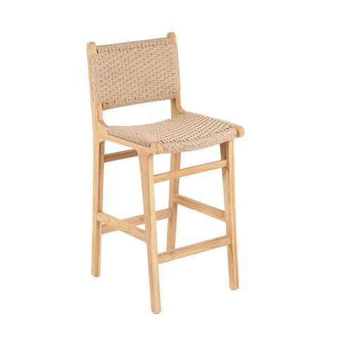 A wooden bar stool with a woven rattan seat and backrest crafted from ecological teak wood. The stool has a light natural finish, featuring a simple, minimalist design with four sturdy legs and a footrest.