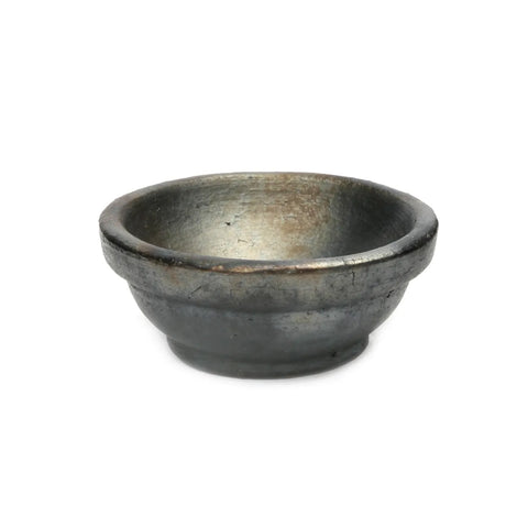 A rustic, dark gray terracotta bowl with a simple, rounded design. The surface boasts a textured and aged appearance, giving it a unique vintage look. This piece of unique tableware is empty and placed against a plain white background.