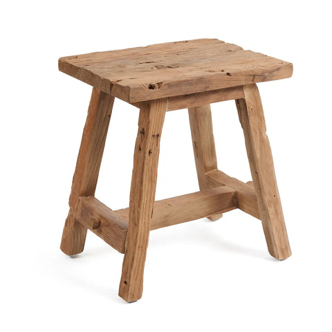 A Shoji stool crafted from reclaimed teak wood with a simple design, featuring a rectangular seat and four sturdy legs. The wood boasts a natural, unfinished look with visible grain and knots, enhancing its rustic vintage charm.