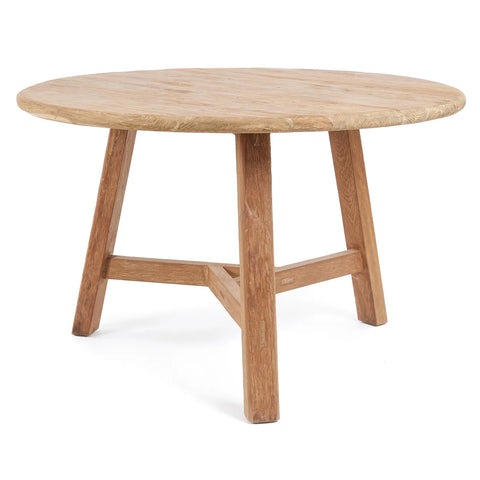 A round wooden table crafted from reclaimed teak wood with a natural finish, featuring a smooth tabletop and sturdy four-legged base. The table embodies a simple, minimalist design that complements any space effortlessly.