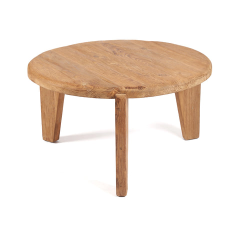 A round wooden coffee table crafted from reclaimed teak wood features a smooth surface and three sturdy, angled legs. Its natural finish highlights the beautiful grain, adding a touch of rustic charm. The eco-friendly piece is set against a plain white background.