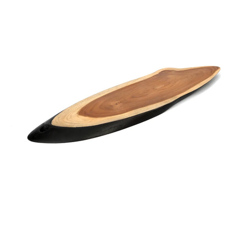 A wooden serving board with a natural, smooth surface and an elongated shape. This handmade piece features a darker, tapered edge on one end and showcases the wood grain throughout. Perfect as teak wood tableware, it elegantly rests on a white background.