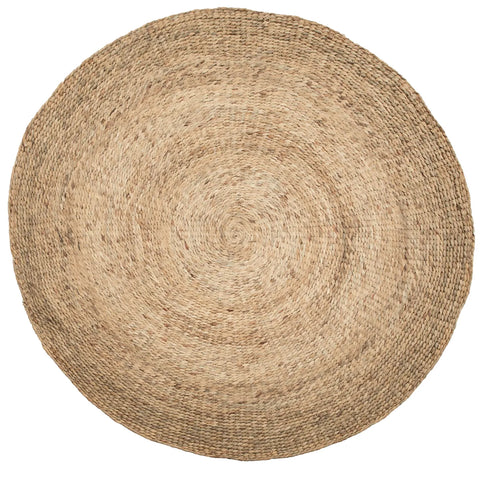 A round, woven jute rug with a natural beige color and a textured surface. The boho pattern consists of concentric circles created by the weaving technique, giving it a rustic and earthy appearance.