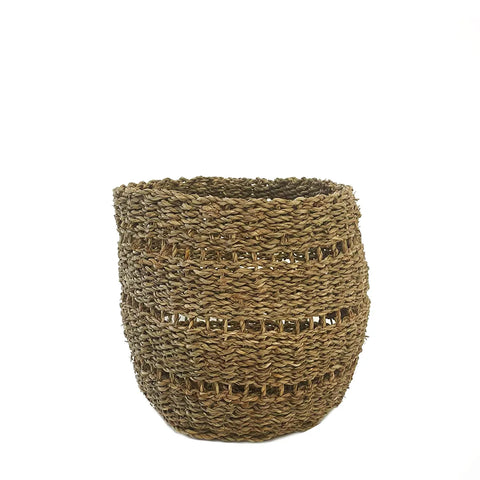 A seagrass woven basket with an open top, crafted from natural fibers, is displayed against a plain white background. It boasts a textured, hand-crafted appearance with alternating tight and loose weaves, perfect for towel storage or laundry storage.