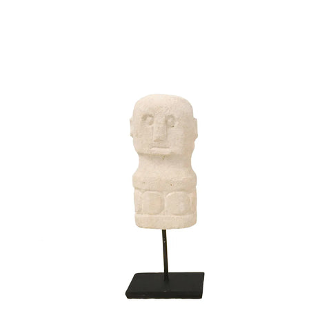 Stone sculpture of a stylized human figure with blocky features, expertly hand-carved and reminiscent of traditional Sumba decor, mounted on a black stand against a plain white background.