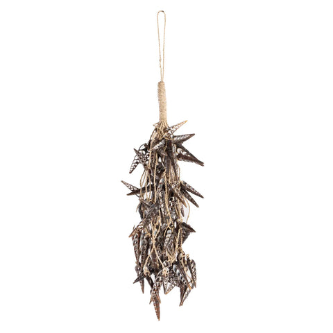 A hanging bundle of dried star-shaped palm seed pods tied with a jute rope, reminiscent of enchanting unicorn horns, isolated on a white background.