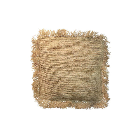 Square handwoven jute pillow with fringed edges, offering a natural, textured finish that complements boho decor.