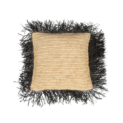 Square woven pillow with a beige center, featuring a fringe of black straw-like material outlining the edges. This raffia handwoven cushion adds a boho touch, enhancing its natural, rustic appearance. Perfect for complementing a villa-style home with its earthy charm.