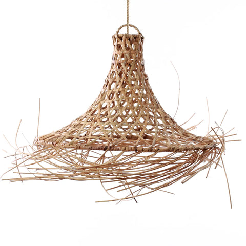 A handcrafted rattan pendant lamp with a conical shape and fringe detail hangs from a cord. The open-weave design exudes a coastal boho vibe, offering a rustic and natural appearance.