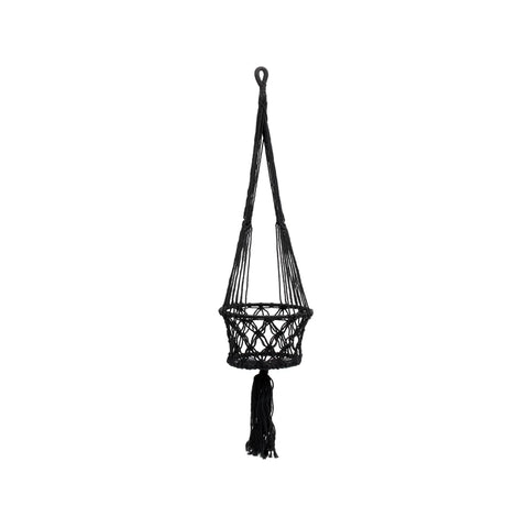 A black macrame plant hanger with an intricate woven design elegantly displays indoor plants against a plain white background. This stylish macramé basket features a long loop at the top and a decorative tassel at the bottom, perfect for showcasing hanging plants.