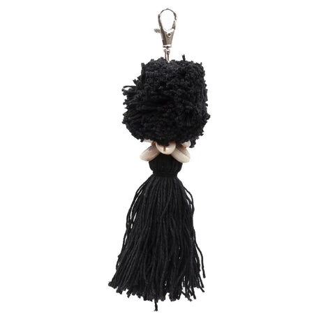 A boho luxury pompom keychain adorned with a black yarn pom-pom at the top and a long black tassel at the bottom, featuring small white beads in the middle. A silver lobster clasp is attached for easy fastening.