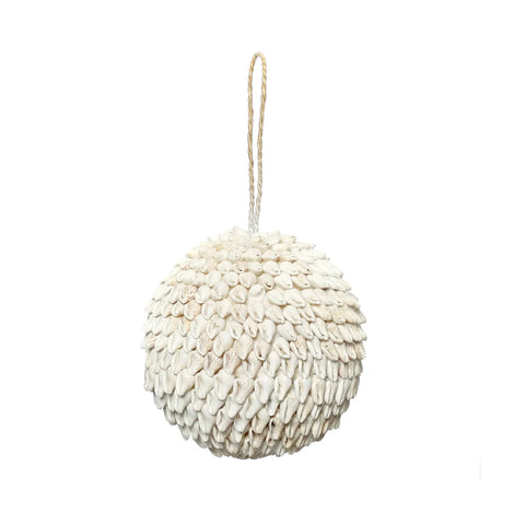 A hand-made, decorative hanging ornament shaped like a sphere is covered in layered, overlapping white shells. Perfect for a bohemian interior, it features a looped string attachment at the top for easy hanging against any plain white background.