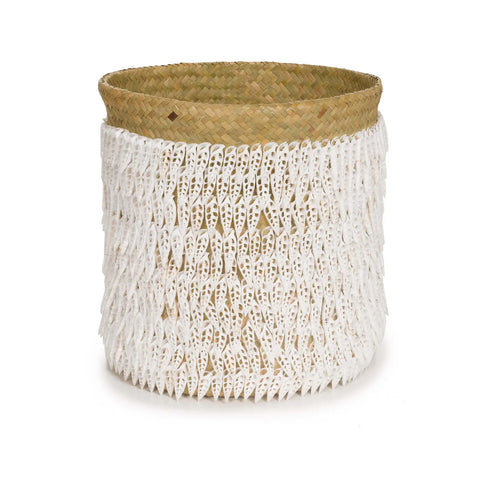 A cylindrical woven pandan basket with a natural brown base and intricate white fringe detailing, featuring delicate Balinese shells adorning its exterior.