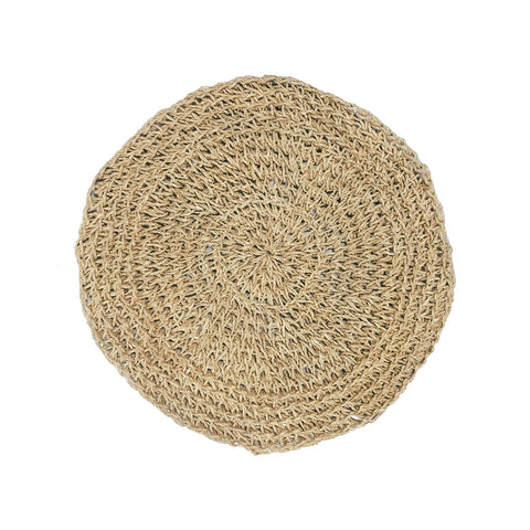 A round, woven straw placemat with intricate patterns, this Seagrass Placemat adds a boho touch to any natural table setting on a white background.