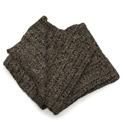 A folded, woven brown scarf with a textured, loose-knit pattern lies against a plain white background, reminiscent of the intricate design of a Seagrass Carpet.