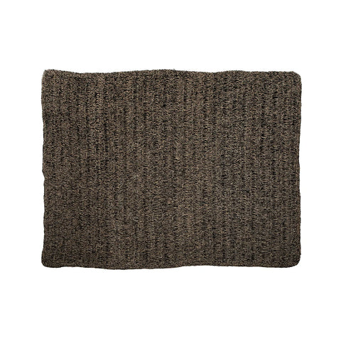 A textured rectangular mat crafted from durable seagrass, boasting a natural black hue. Its hardwearing weave is set against a crisp white background, offering a striking contrast.