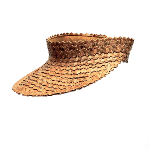 A hand-woven visor hat made of natural brown straw material and bamboo, featuring a textured pattern with overlapping layers. The design includes an extended brim and an open top, reminiscent of a traditional Balinese cap, set against a plain white background.