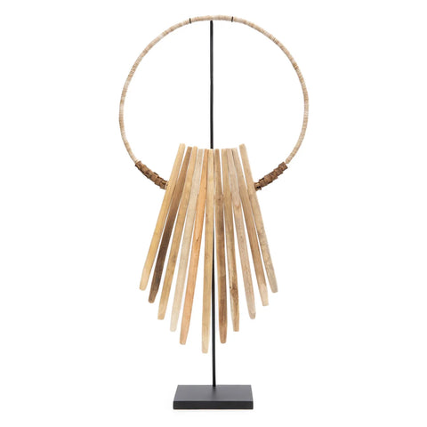 A unique centrepiece, this modern art sculpture showcases vertical wooden slats arranged in a fan shape, reminiscent of driftwood art found on Bali beaches. Mounted on a slender black stand and framed by a large circular ring, it creates an abstract and geometric design.