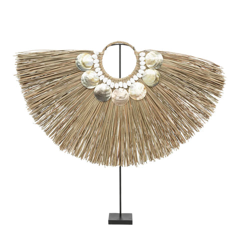 A decorative piece showcasing bohemian beauty with a fan-shaped alang grass display, adorned with hand-placed shell-like ornaments and smaller round beads in the center, all mounted elegantly on a black stand.