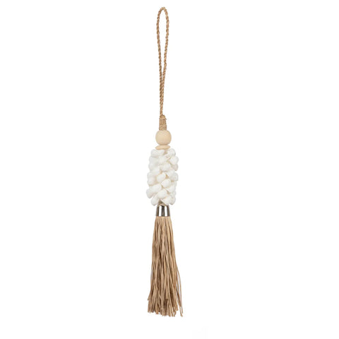 This decorative tassel, crafted by Balinese craftsmen, features a knotted white woven section attached to a natural brown fringe. It’s connected to a rope loop for hanging, and adorned with a small wooden bead above the weave, exuding a bohemian atmosphere.