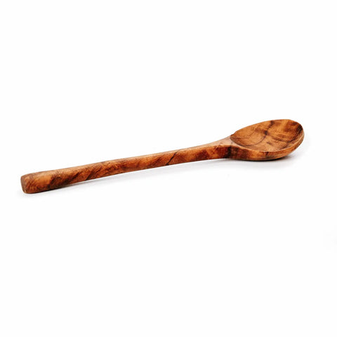 A handmade spoon crafted from teak root, featuring a smooth texture and rounded tip, is displayed on a white background. Perfect for an elegant table setting.