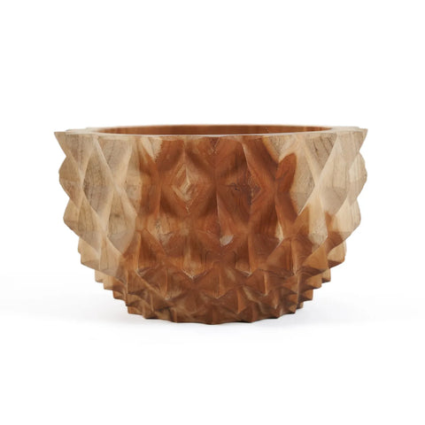 A textured wooden bowl with a geometric, faceted design in durable teak wood. The intricate carving forms triangular shapes, making it an elegant and unique decorative centerpiece.