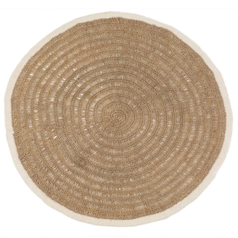 A round, woven jute rug with a concentric circle pattern features a natural beige color contrasted by a thin white border. This hardwearing rug offers an earthy, minimalist aesthetic to any space.