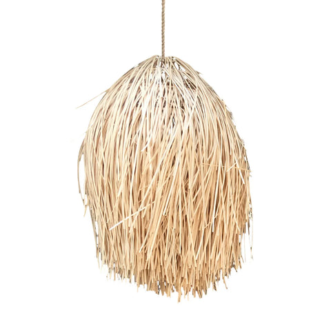 A cozy rattan pendant lamp, crafted from natural beige straw or raffia strands, hangs gracefully in a dome shape. The cascading fibers create a textured, boho look. This inviting light is suspended by a single cord against a clean white background.