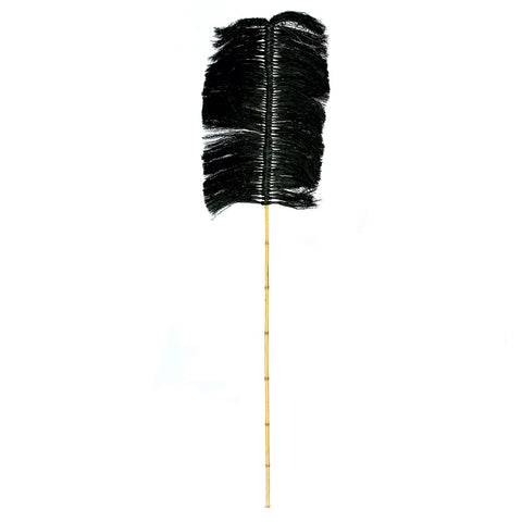 A black feather duster with an extended wooden handle resembles a bamboo branch, adding a subtle decorative element against a white background.