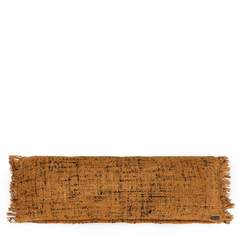 A rectangular, textured, mustard-colored pillow with fringed edges exudes a boho vibe against a white background. This decorative piece not only boasts a woven appearance but is also a unique textile product that adds charm to any space.